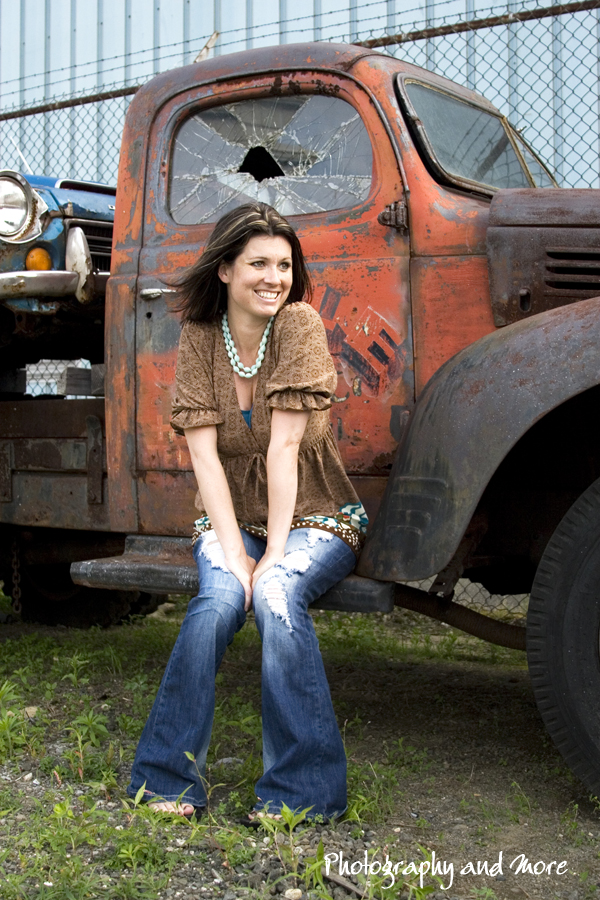 A young girl posing in front of an old car for a lifestyle photo